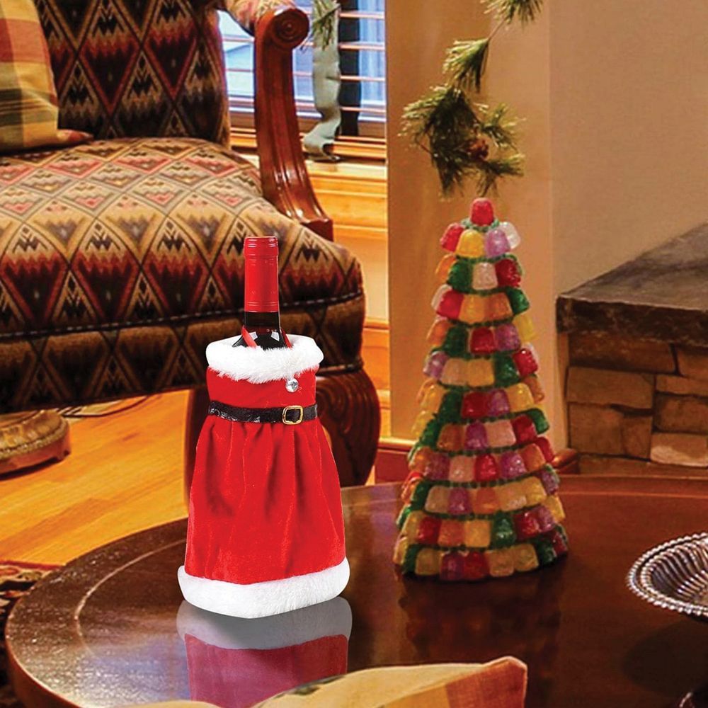 d61b75f49571c72a23ec1b926bfc5591 Christmas Bottle Cover "Christmas Dress" Pattern RC-K-301 Multicolor Bottle Decoration for the Holidays This charming bottle cover in the shape of a Christmas dress is a delightful way to decorate bottles during the Christmas season. Perfect for gifts, Christmas table decorations, or as a fun addition to bottles of drinks during holiday parties. Colorful, Festive Design The cover features a cheerful mix of red, green, and white, creating a joyful holiday atmosphere. It looks like a mini dress, giving the bottle a unique and decorative touch. Versatile Use Ideal for wine, champagne, juice, or any other bottles. A perfect way to transform an ordinary bottle into a festive holiday decoration. Great Gift Idea This bottle cover also makes a great gift idea – a decorated bottle becomes an original and special present for loved ones. ✅ Specifications: Model: RC-K-301 Pattern: Christmas dress Color: Multicolor (red, green, white) Use: Bottle decoration, gift, Christmas table ornament Material: Fabric ✨ Add a touch of holiday magic – beautiful bottle cover for your celebrations!